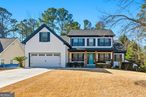 a front view of a house with a yard and garage
