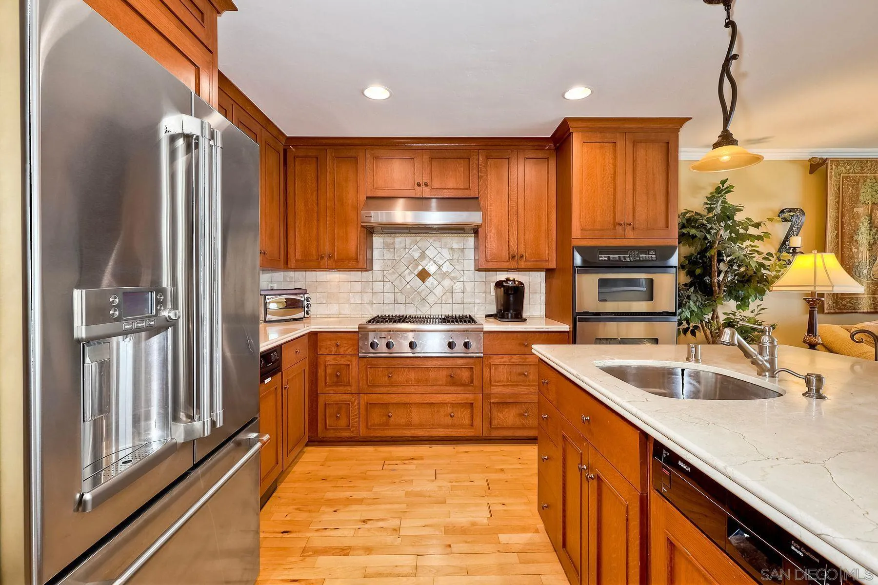 720 4th Street, Unit 1 Encinitas, CA 92024 - Photo 4 of 29 a large kitchen with stainless steel appliances granite countertop a stove a sink and a refrigerator
