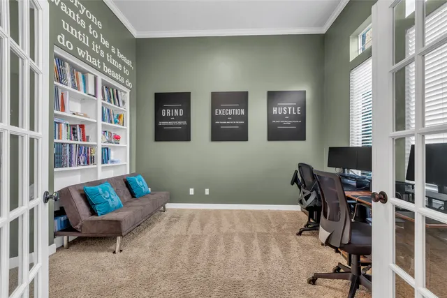 a living room with furniture and a book shelf