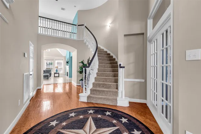 a view of entryway and hall with wooden floor