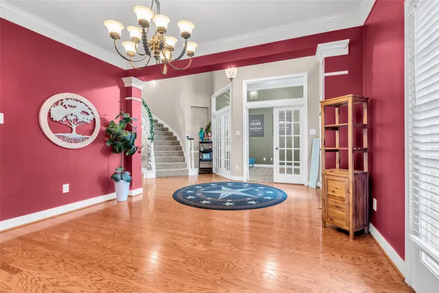 a view of a room with a chandelier furniture and a large window
