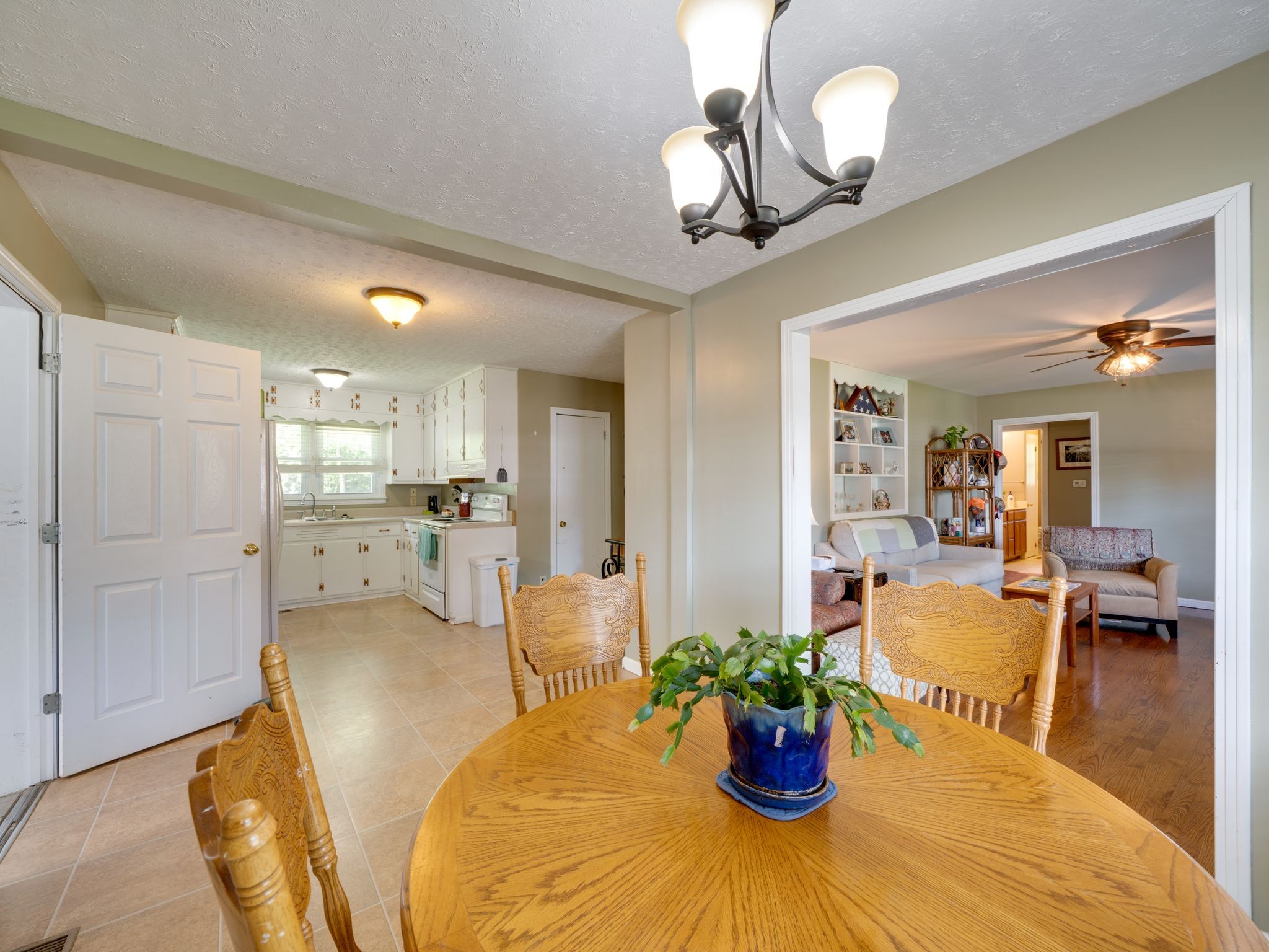 125 The Trace Dover, TN 37058 - Photo 9 of 29 a view of a dining room and kitchen with furniture wooden floor and a chandelier