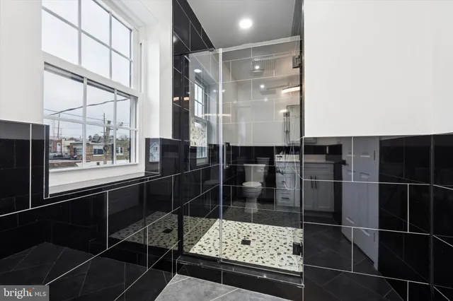 a bathroom with a glass shower door