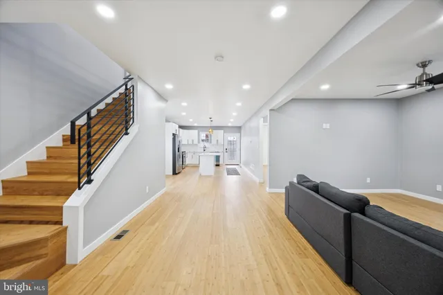 a view of hallway with wooden floor and staircase