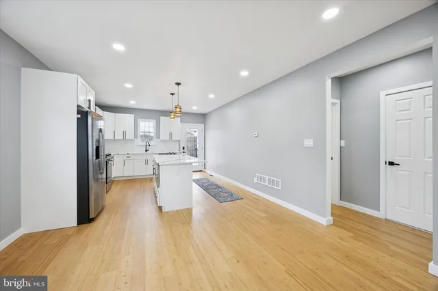 a large kitchen with a lot of counter space and stainless steel appliances