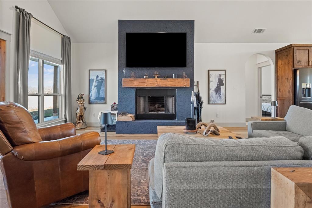 618 Minnis Road Collinsville, TX 76233 - Photo 13 of 37 a living room with furniture a flat screen tv and a fireplace