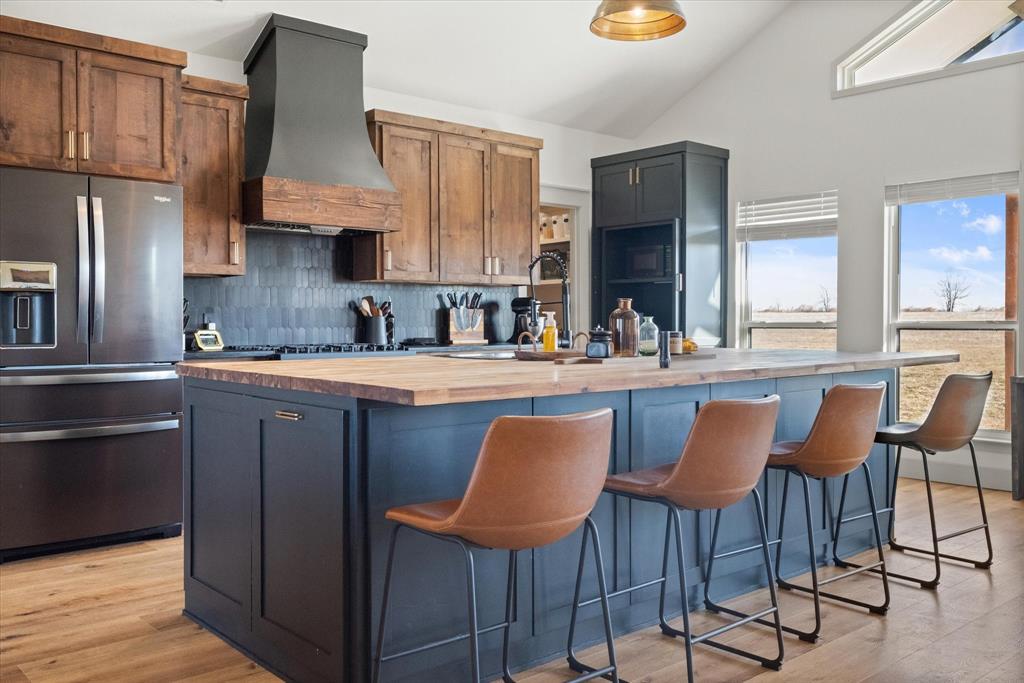 618 Minnis Road Collinsville, TX 76233 - Photo 17 of 37 a kitchen with stainless steel appliances granite countertop a sink and a refrigerator