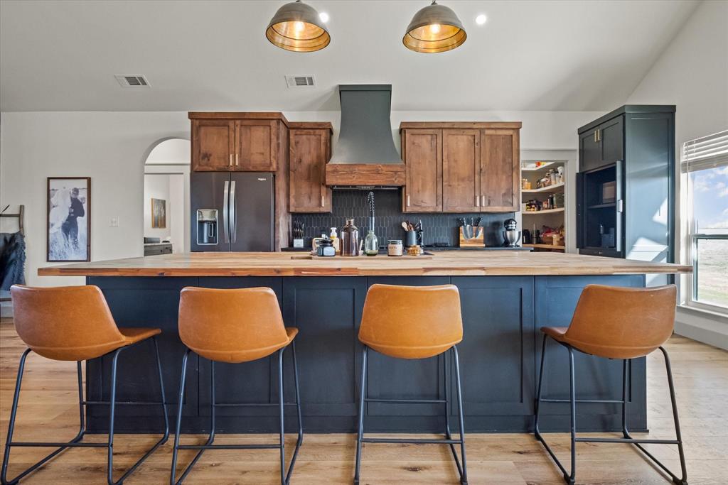618 Minnis Road Collinsville, TX 76233 - Photo 18 of 37 a kitchen with stainless steel appliances kitchen island granite countertop a table and chairs