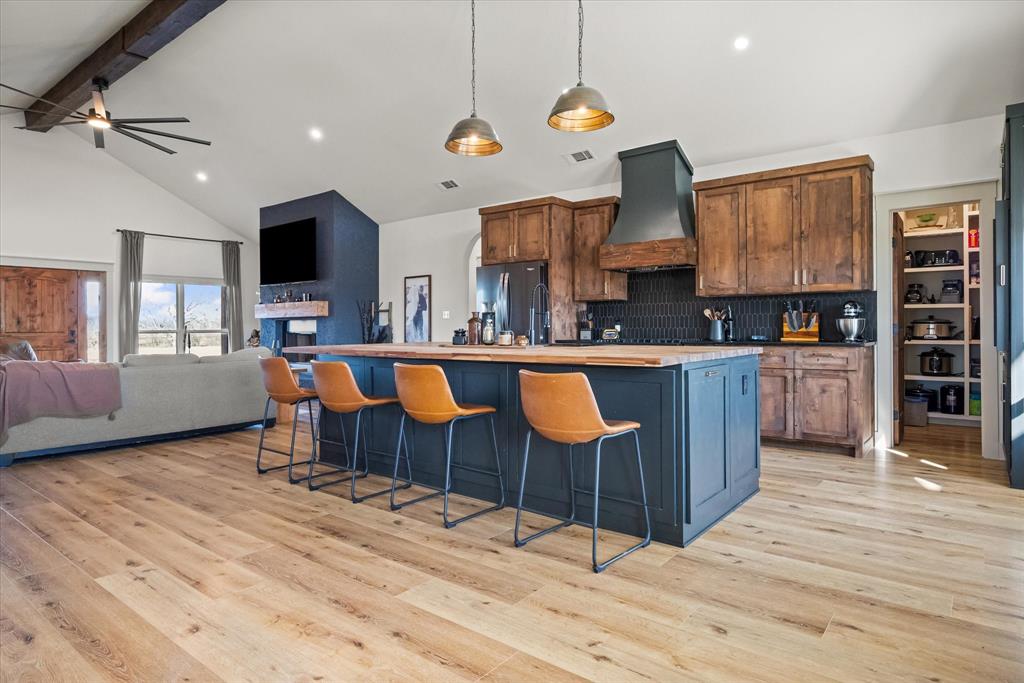 618 Minnis Road Collinsville, TX 76233 - Photo 19 of 37 a living room with kitchen island granite countertop furniture and a wooden floor