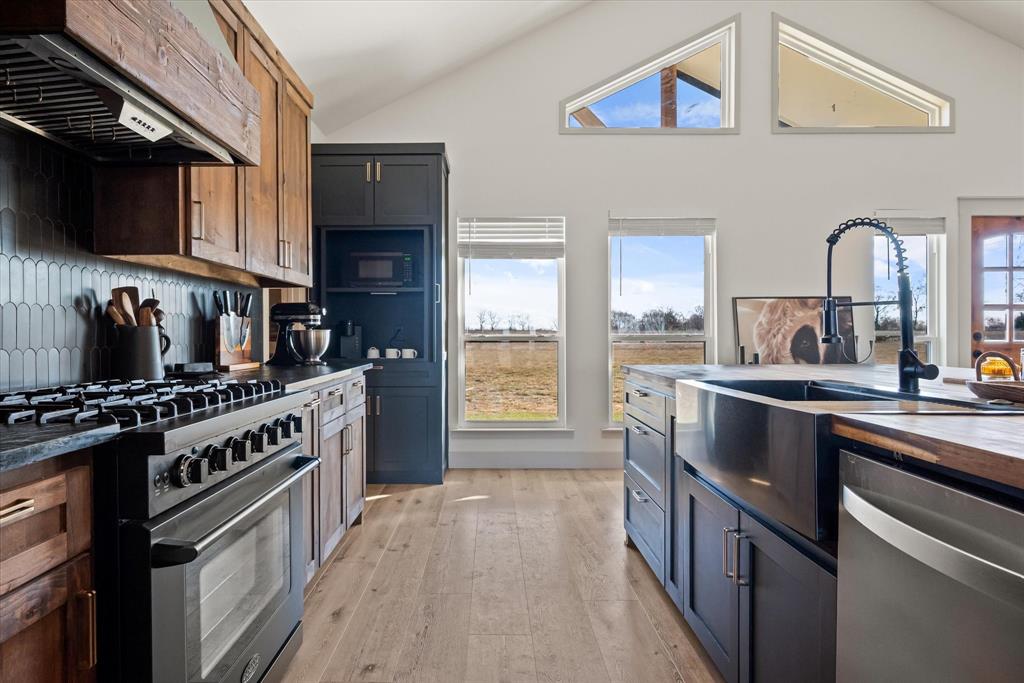 618 Minnis Road Collinsville, TX 76233 - Photo 22 of 37 a kitchen with stainless steel appliances a stove a sink and a refrigerator