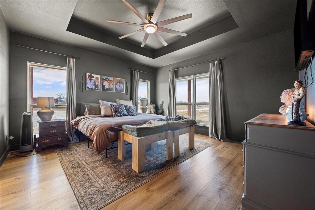 618 Minnis Road Collinsville, TX 76233 - Photo 23 of 37 a bedroom with a large bed and a chandelier