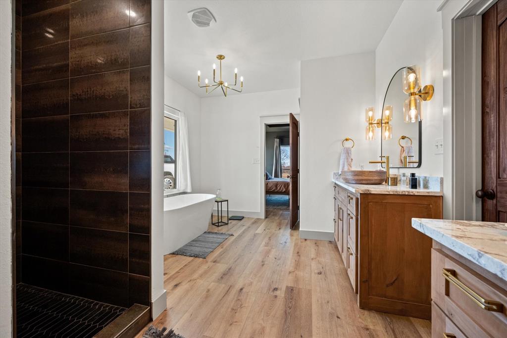 618 Minnis Road Collinsville, TX 76233 - Photo 28 of 37 a large kitchen with a sink and dishwasher a stove top oven with wooden floor