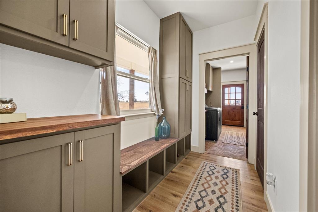 618 Minnis Road Collinsville, TX 76233 - Photo 33 of 37 a hallway with white cabinets and wooden floor