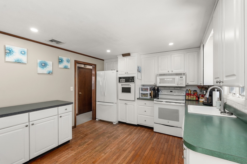 7 Van Beal Road Randolph, MA 02368 - Photo 11 of 35 a kitchen with stainless steel appliances a refrigerator sink and microwave