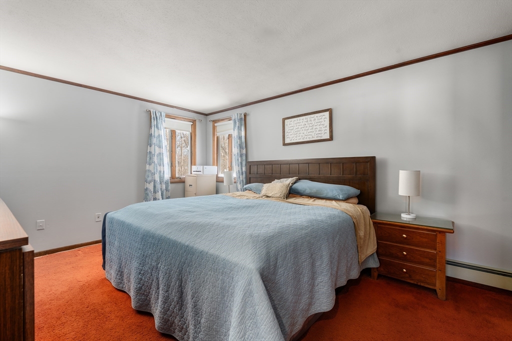 7 Van Beal Road Randolph, MA 02368 - Photo 13 of 35 a bedroom with a bed and a lamp on the dresser