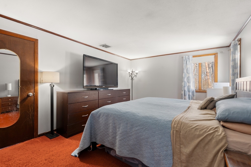 7 Van Beal Road Randolph, MA 02368 - Photo 14 of 35 a bedroom with a bed and a flat screen tv