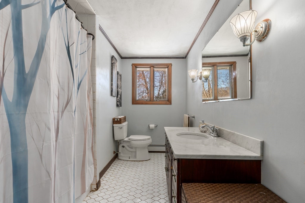 7 Van Beal Road Randolph, MA 02368 - Photo 19 of 35 a en suite bathroom with a sink a mirror and a toilet