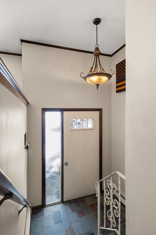 7 Van Beal Road Randolph, MA 02368 - Photo 21 of 35 a room with a chandelier fan and a wooden floor