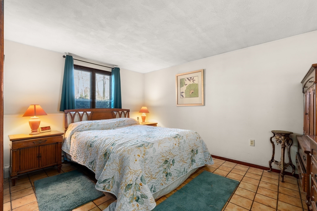 7 Van Beal Road Randolph, MA 02368 - Photo 27 of 35 a bedroom with a bed and wooden floor