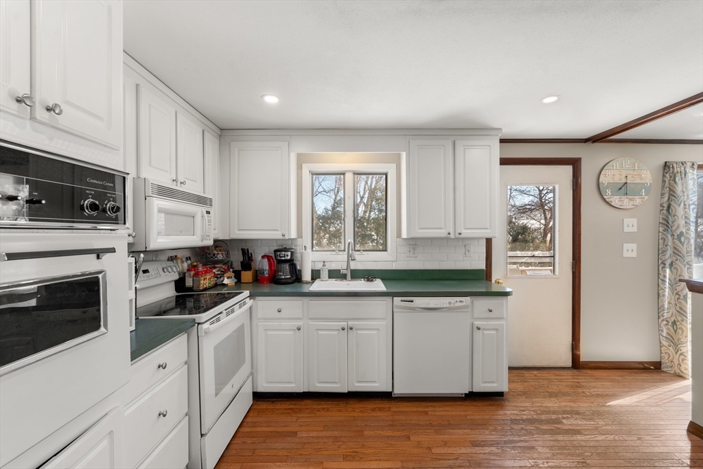 7 Van Beal Road Randolph, MA 02368 - Photo 9 of 35 a kitchen with granite countertop a sink cabinets stainless steel appliances and a window