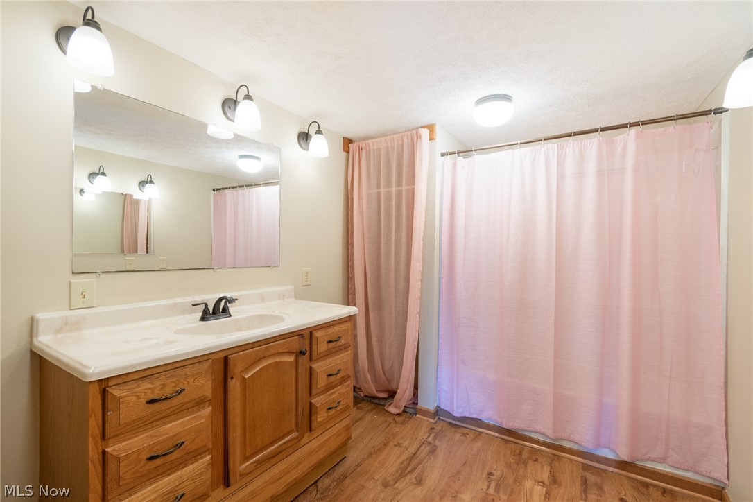 16333 Courtney Road Alliance, OH 44601 - Photo 25 of 31 Bathroom featuring vanity and wood-type flooring