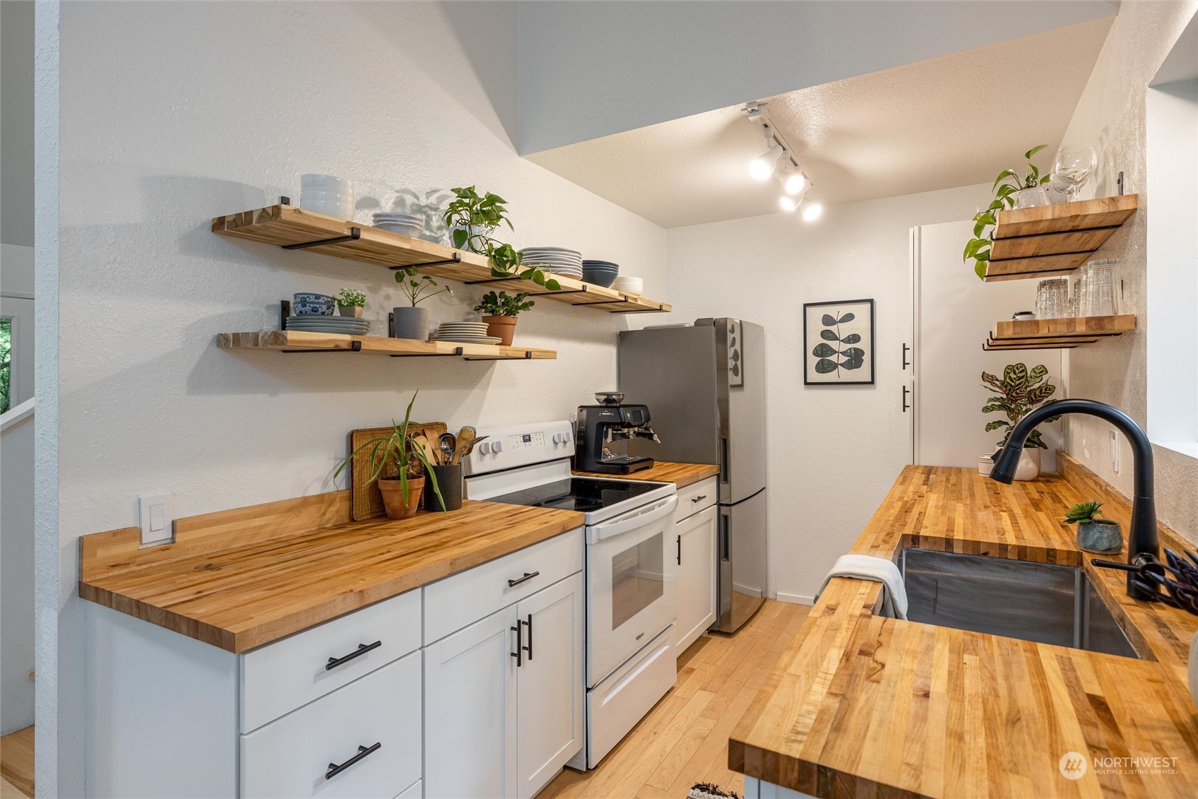 32-34 Maple Court Bellingham, WA 98229 - Photo 11 of 31 a kitchen with kitchen island granite countertop a sink stainless steel appliances and cabinets