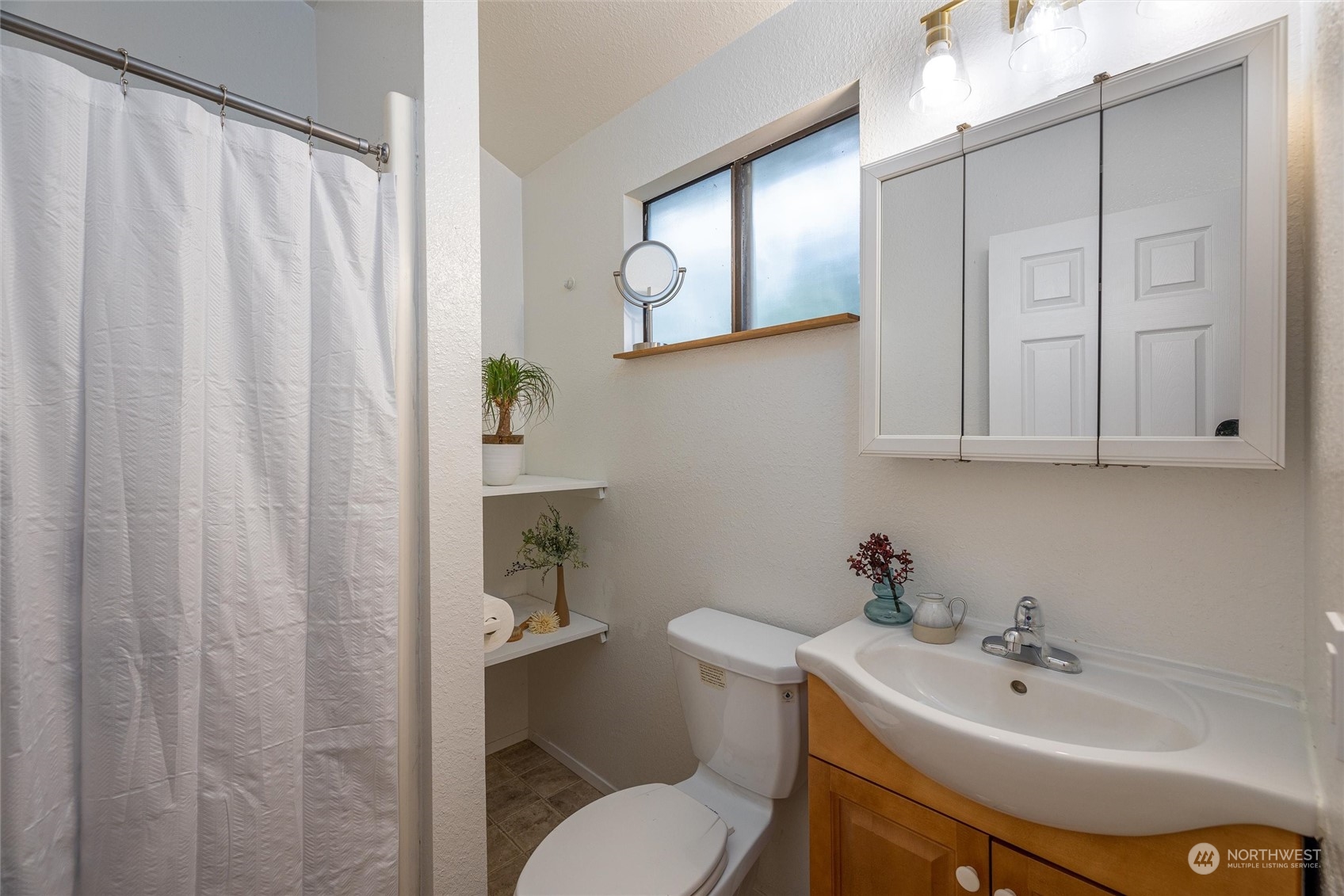 32-34 Maple Court Bellingham, WA 98229 - Photo 19 of 31 a bathroom with a sink a toilet and a mirror