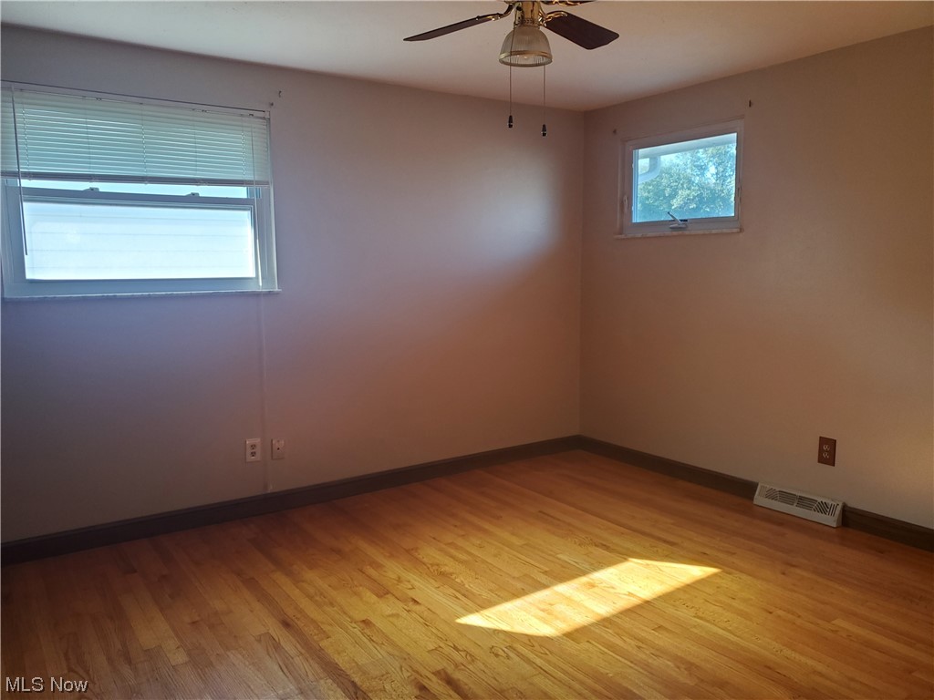 12221 Reno Drive Parma, OH 44130 - Photo 23 of 29 Hardwood floored spare room with ceiling fan