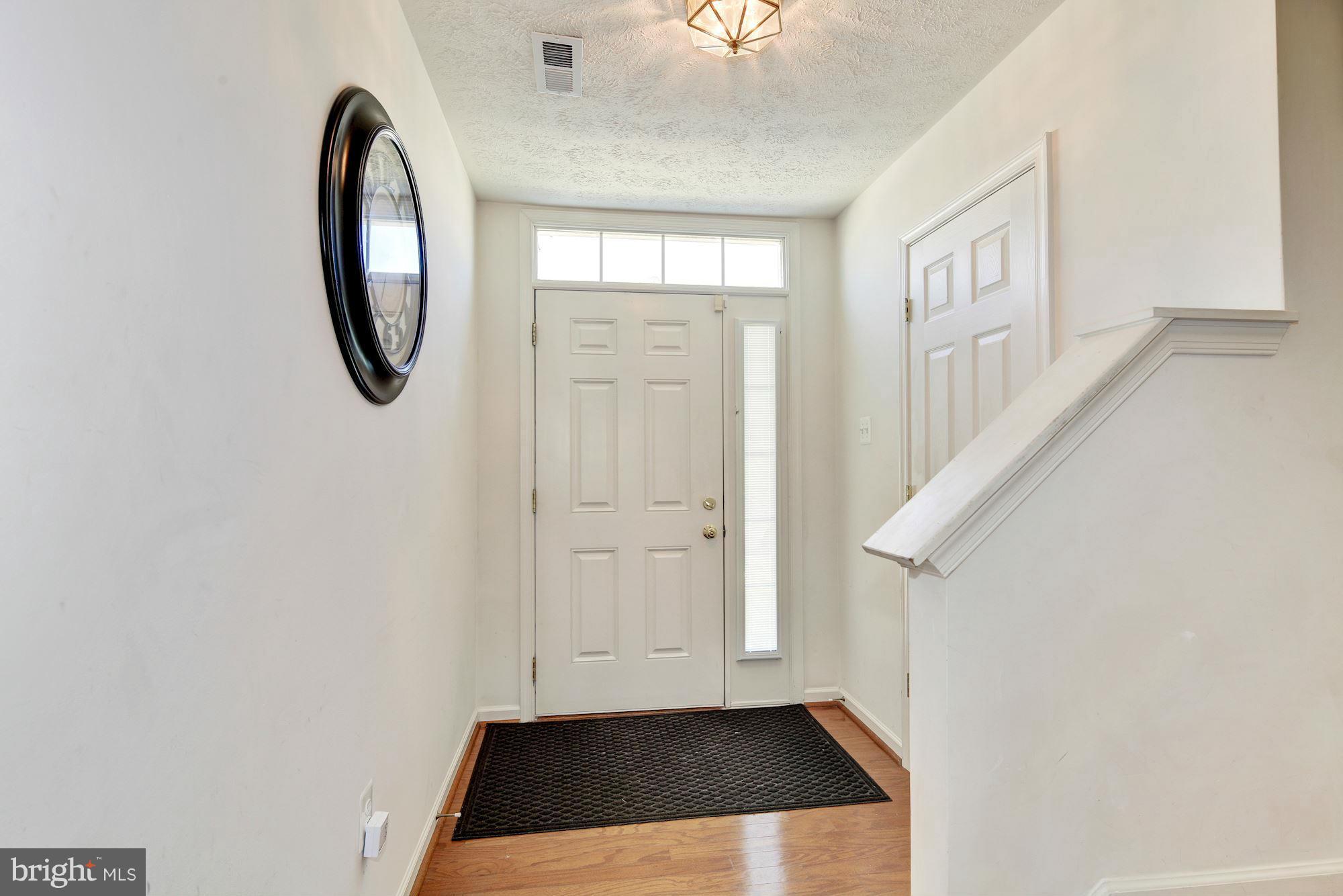 9851 Decatur Road Baltimore, MD 21220 - Photo 2 of 24 a view of a livingroom with wooden floor and entryway