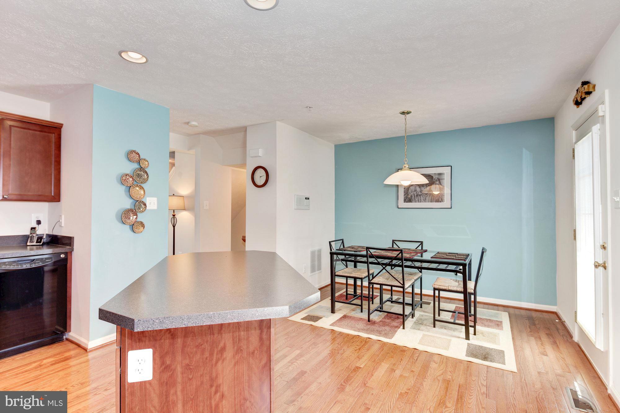 9851 Decatur Road Baltimore, MD 21220 - Photo 12 of 24 a dining room with furniture and wooden floor