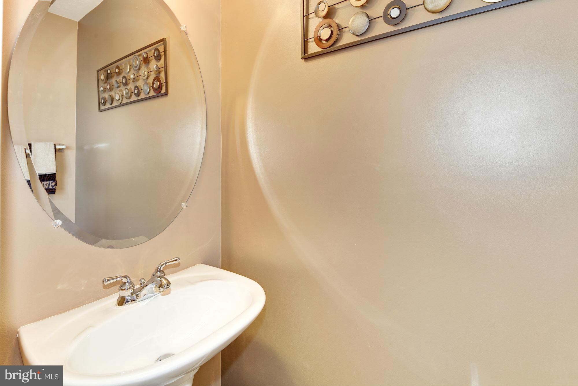 9851 Decatur Road Baltimore, MD 21220 - Photo 16 of 24 a bathroom with a sink and a mirror