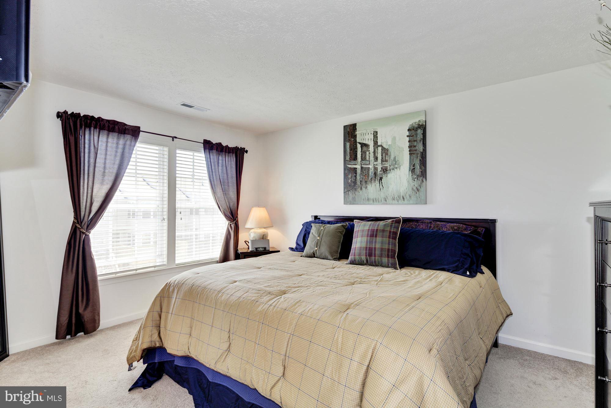 9851 Decatur Road Baltimore, MD 21220 - Photo 17 of 24 a bedroom with a large bed and a large window