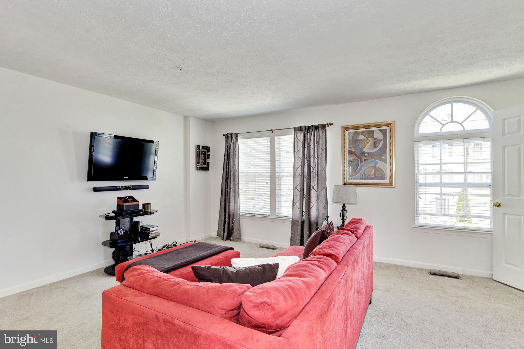 9851 Decatur Road Baltimore, MD 21220 - Photo 6 of 24 a living room with furniture and a flat screen tv