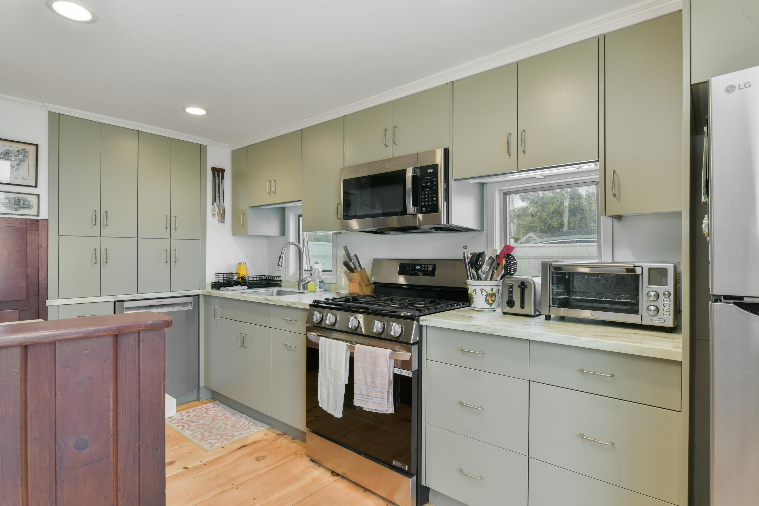 645 South Orleans Road Orleans, MA 02653 - Photo 11 of 57 a kitchen with stainless steel appliances granite countertop a stove a sink and a microwave