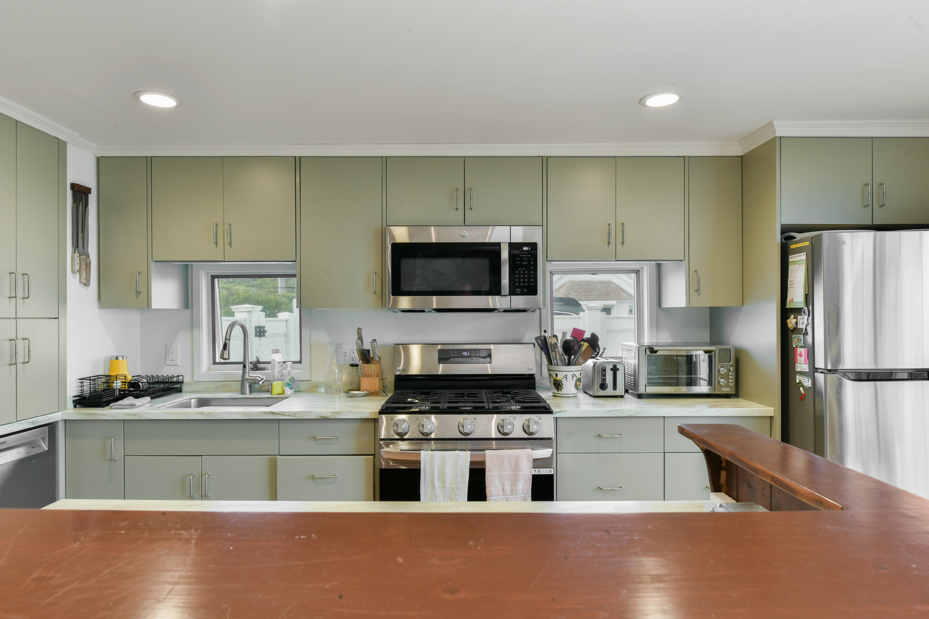 645 South Orleans Road Orleans, MA 02653 - Photo 12 of 57 a kitchen with kitchen island a sink stainless steel appliances and cabinets