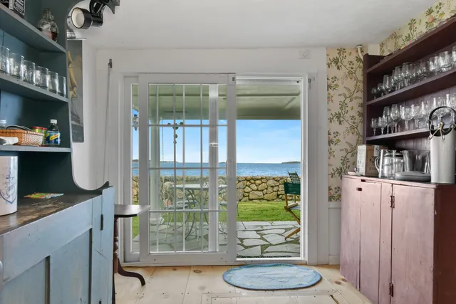 a living room with furniture a fireplace and a large window