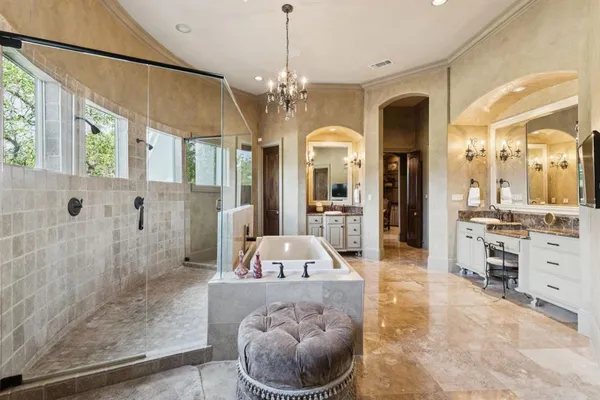 a en suite spacious bathroom with a granite countertop sink a mirror and shower