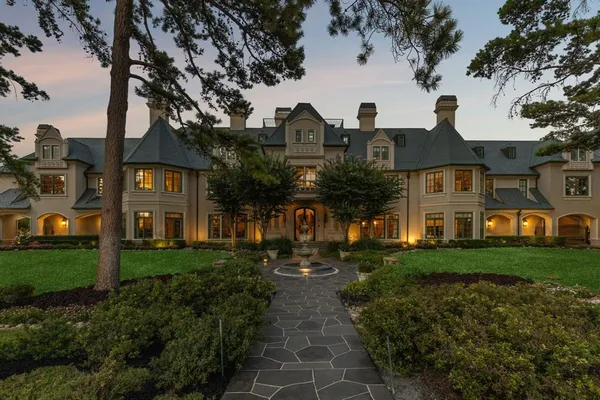 a front view of house with yard and green space