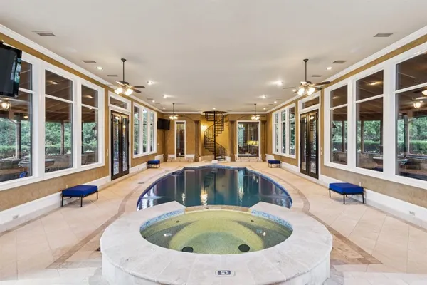 a swimming pool with outdoor seating and yard