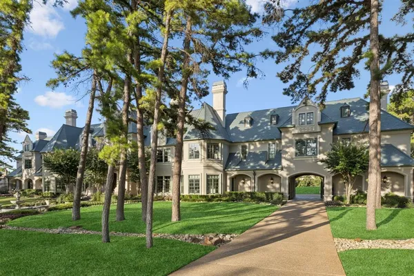 a front view of a building with a garden