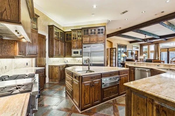 a kitchen with stainless steel appliances granite countertop a stove and a sink