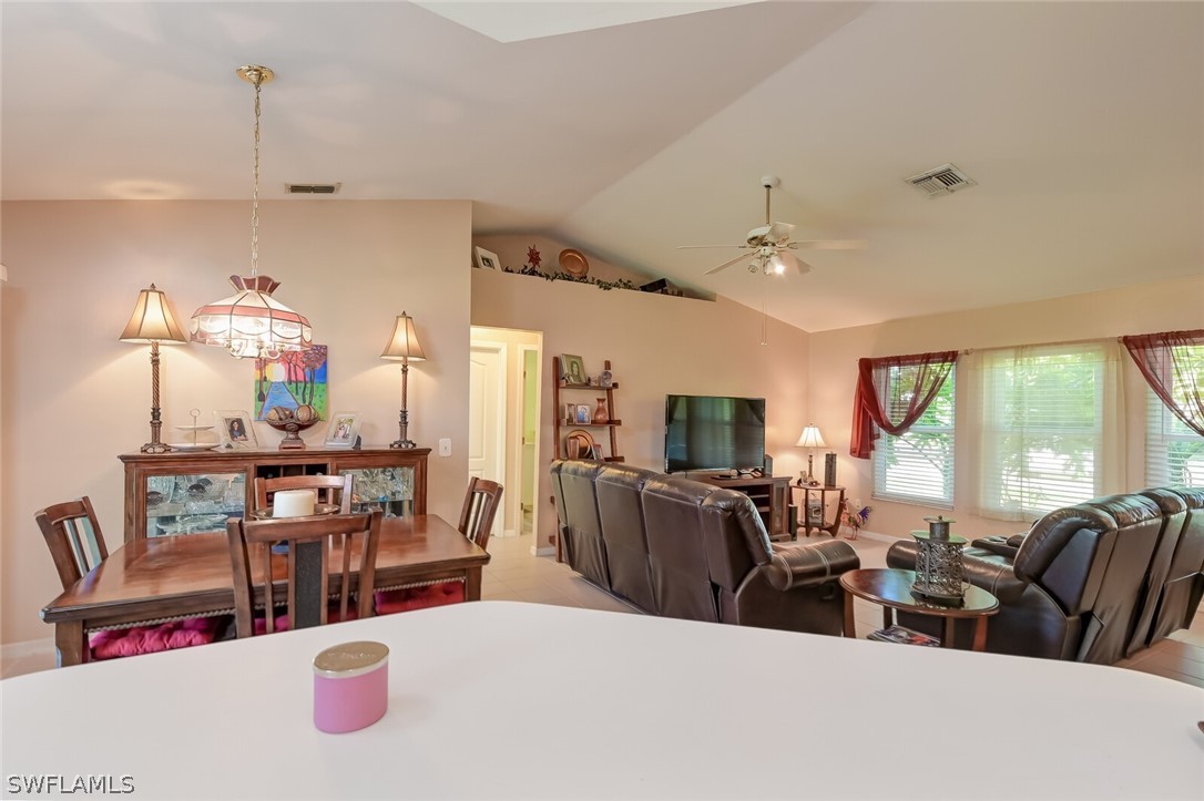 18253 Maple Road Fort Myers, FL 33967 - Photo 12 of 29 a living room with furniture kitchen view and a large window