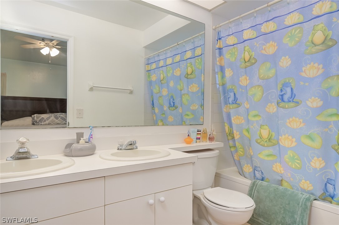 18253 Maple Road Fort Myers, FL 33967 - Photo 15 of 29 a bathroom with a sink a toilet and shower curtain