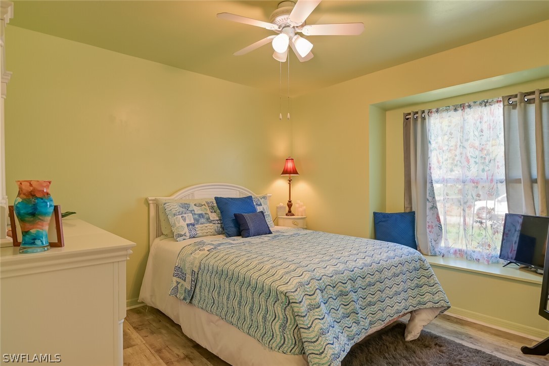 18253 Maple Road Fort Myers, FL 33967 - Photo 17 of 29 a bedroom with a bed and a table