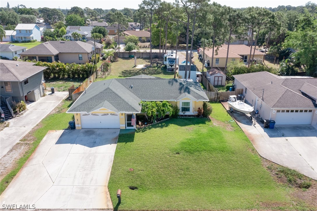 18253 Maple Road Fort Myers, FL 33967 - Photo 2 of 29 an aerial view of a house with a garden and trees