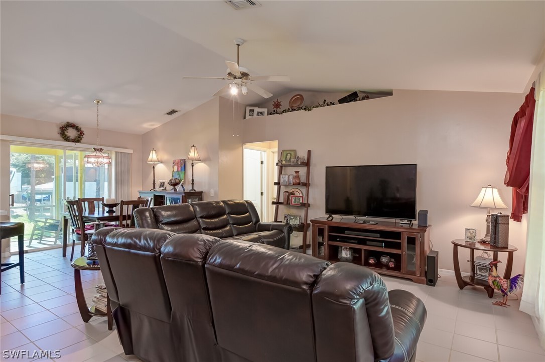 18253 Maple Road Fort Myers, FL 33967 - Photo 5 of 29 a living room with furniture and a flat screen tv