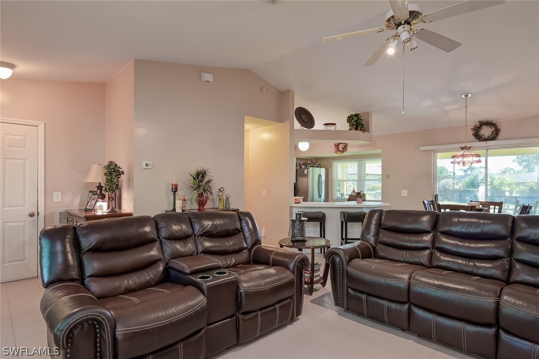 18253 Maple Road Fort Myers, FL 33967 - Photo 6 of 29 a living room with furniture ceiling fan and a large window