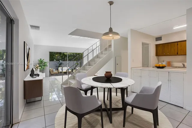 a dining room with furniture and window