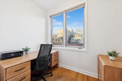 a room with a window and a dresser