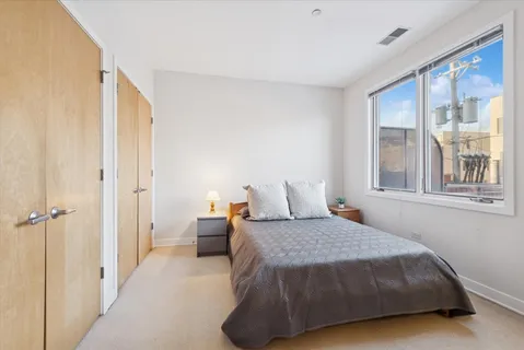a bedroom with a bed and glass window